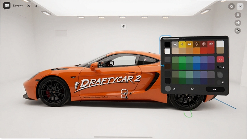 DRAFTYCAR 2 车辆涂装编辑界面,展示车身侧面贴纸拖拽操作,主体为亮橙色跑车与悬浮调色盘,背景为纯白工作室环境,界面简洁现代